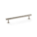 Metal cabinet handle with textured design on a white background