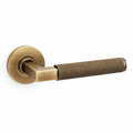 Hurricane knurled lever on rose door handle - antique brass