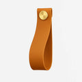 Brown leather strap with a gold button on a light gray background