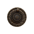 Decorative bronze door knocker on a white background