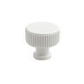 White cabinet knob with ribbed design on a white background