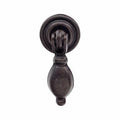 A black cabinet drop pull handle with a traditional design.
